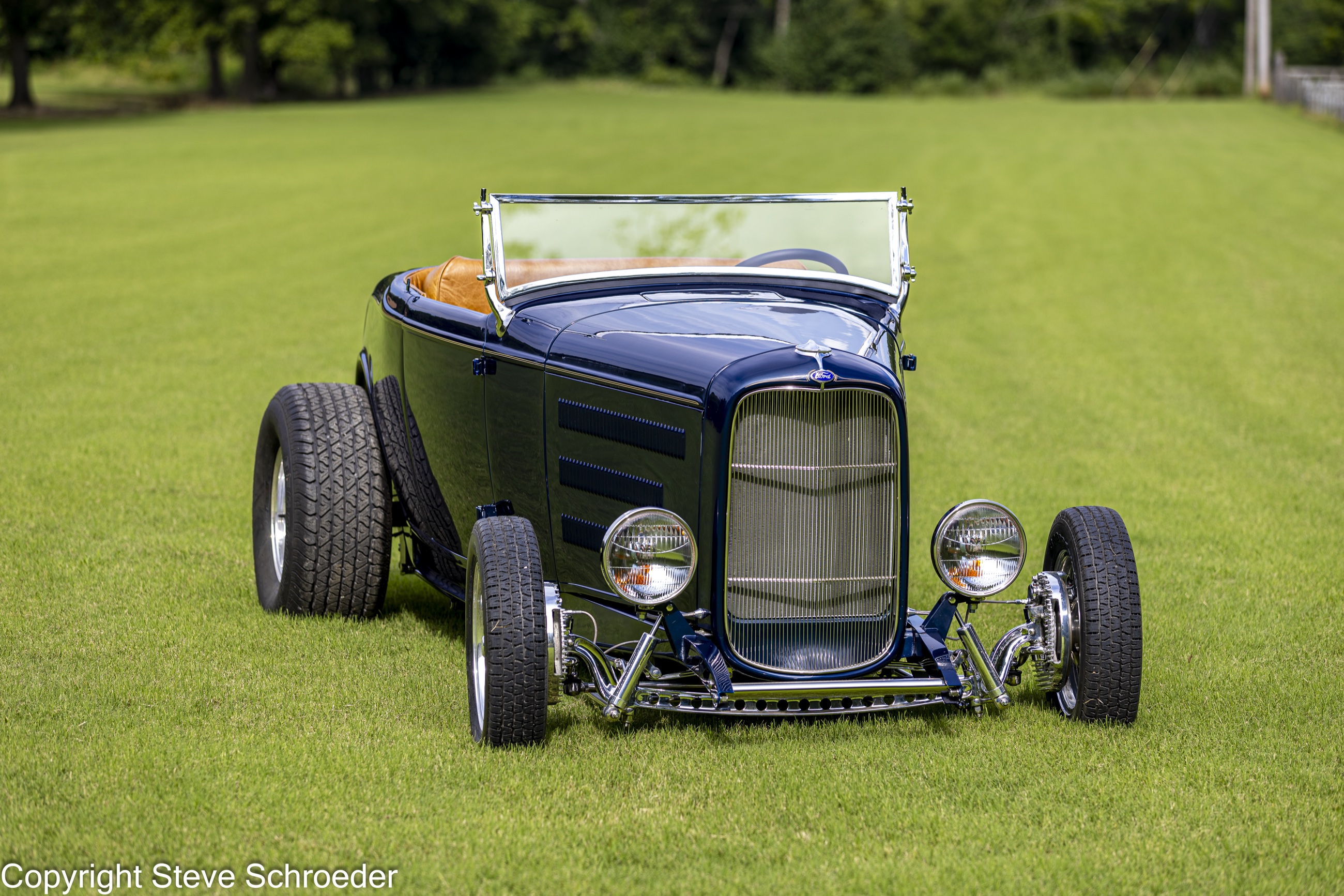 Front portrait of Bob's Nightmist Blue 1932 Ford Roadster on a green lawn