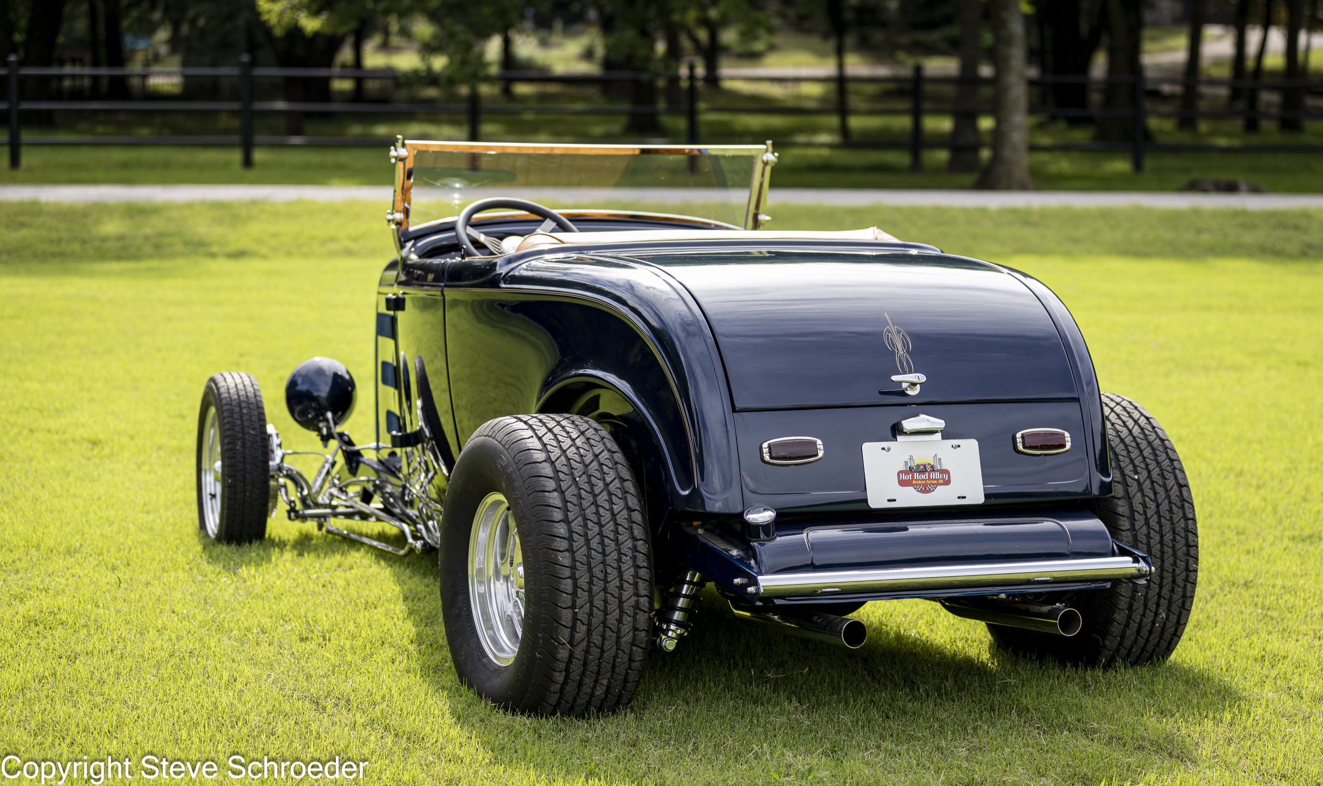 Rear three-quarter view showing the Roadster's wide rear tires